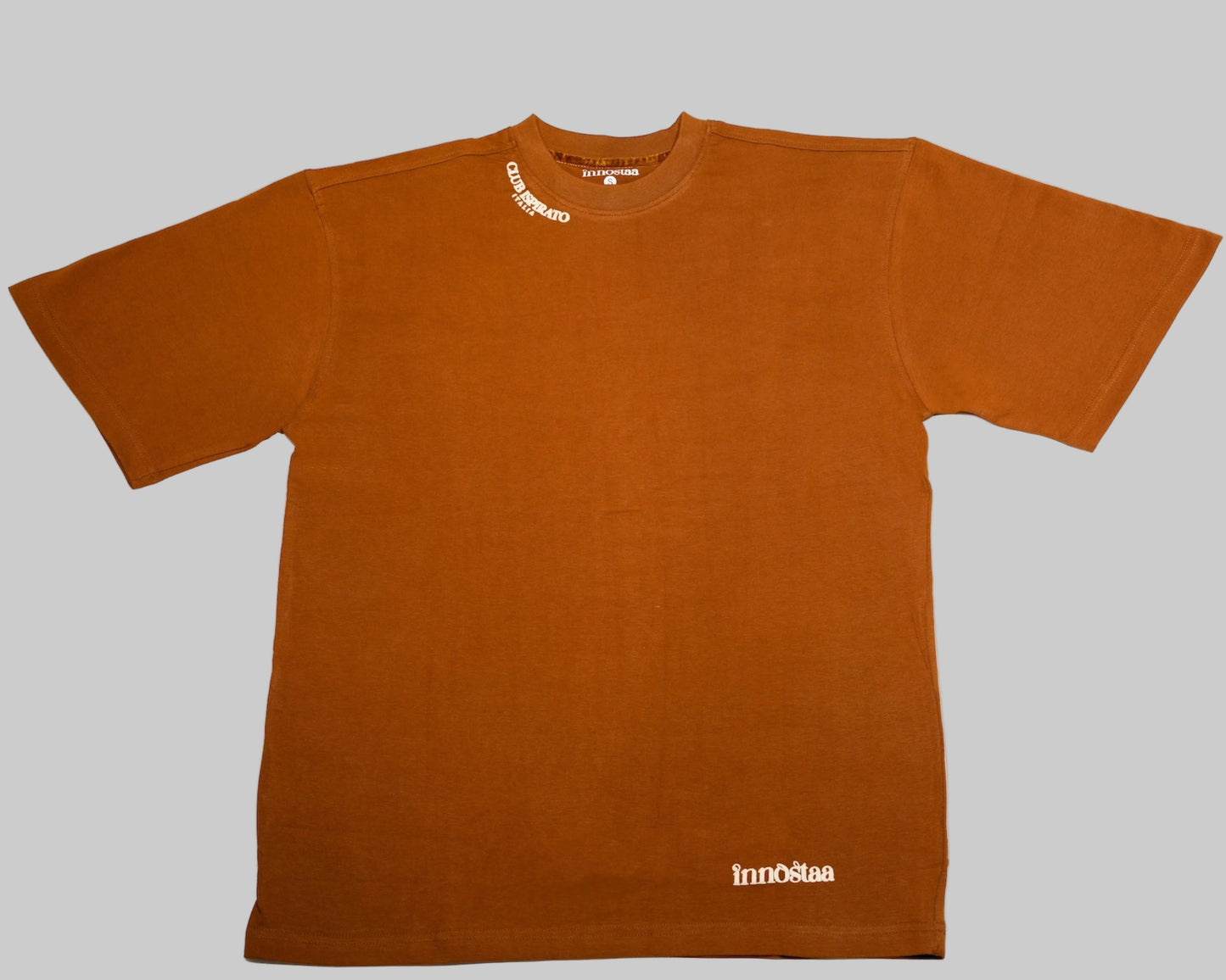 Front side of Rust Brown 100% Cotton T-shirt with puff printed "Innosta" logo on a white background