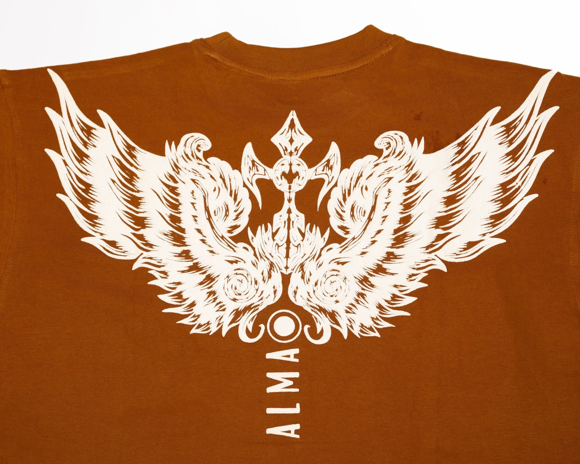 Brown t-shirt with Puff Printed white wings and 'ALMA' text on a plain background